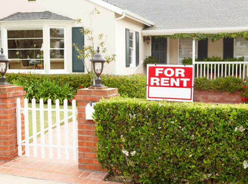 House with a For Rent sign outside.