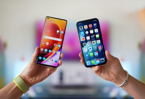 Two hands holding different smartphones side by side